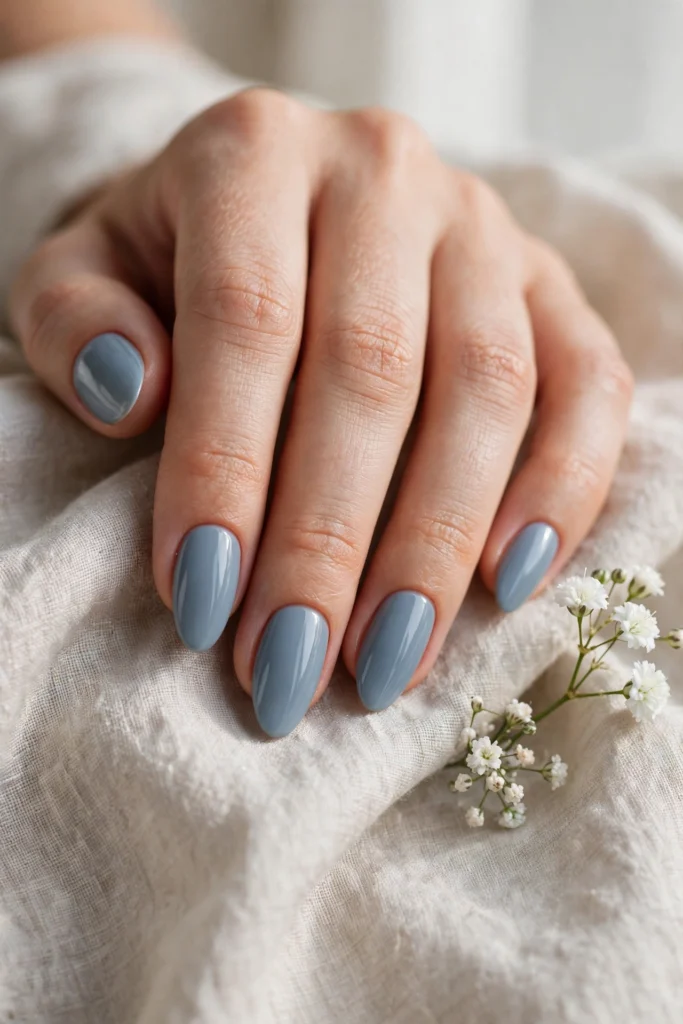 Dusty blue manicure on elegant nails